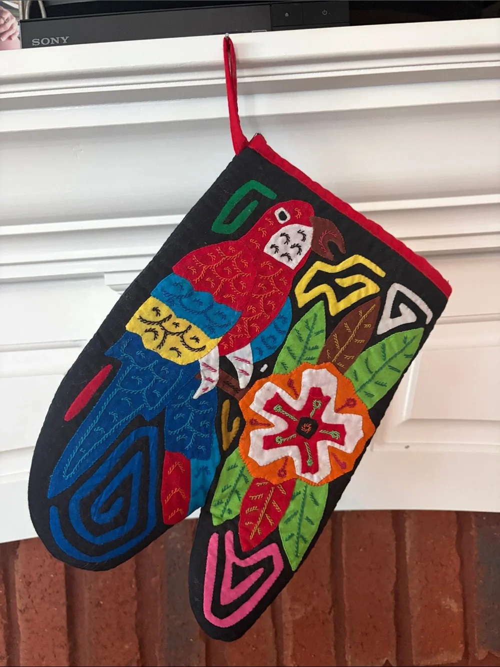 Mola kitchen mitt or decor SanBlas Panama Parrot hand embroidery.